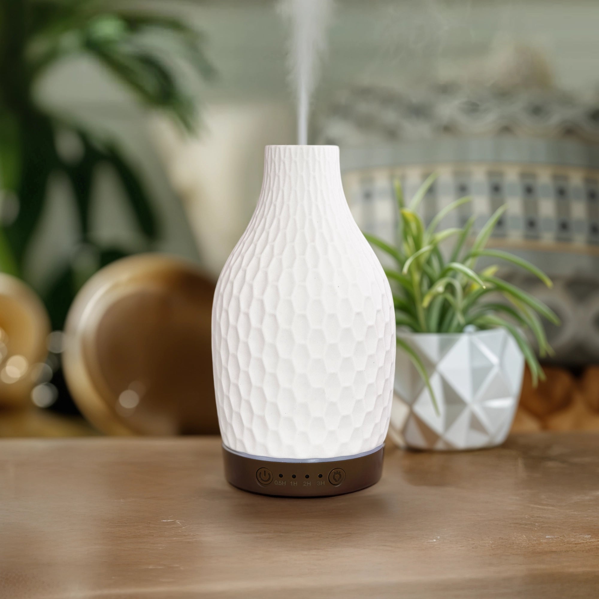 IRIS Celeste ultrasonic aroma diffuser misting on a living room console